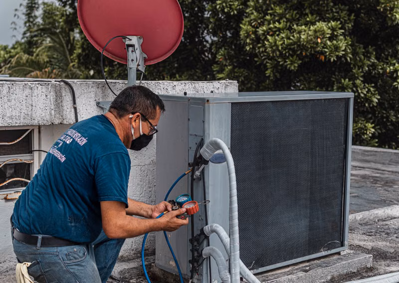 Technician inspecting HVAC unit